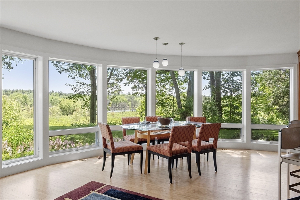 389 River Road Carlisle, MA 01741 - Photo 16 of 42 a view of a dining room with furniture window and outside view