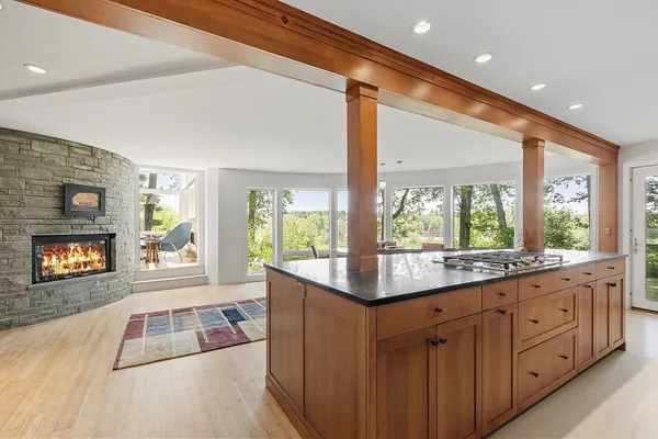 a kitchen with wooden cabinets and a large window