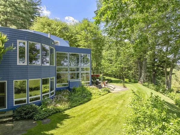 a view of a house with pool and garden