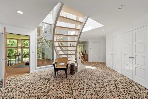 a view of a livingroom with furniture and staircase