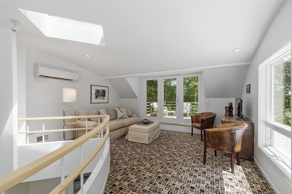 389 River Road Carlisle, MA 01741 - Photo 27 of 42 a living room with furniture and a large window