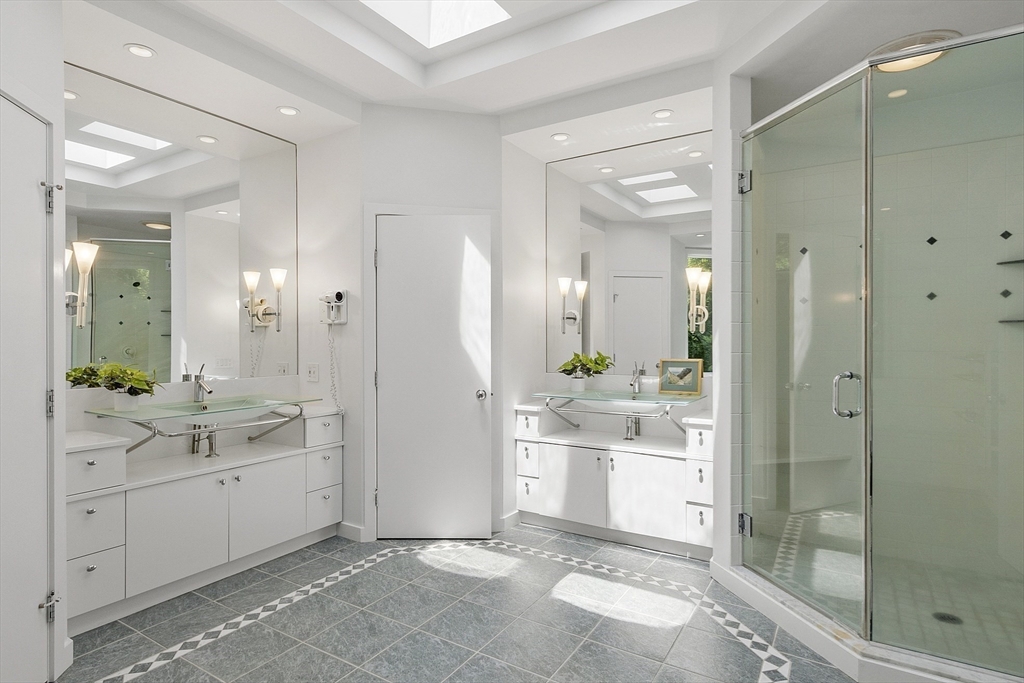 389 River Road Carlisle, MA 01741 - Photo 31 of 42 a bathroom with a double vanity sink mirror and shower