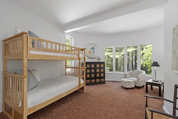 a bedroom with furniture and a window