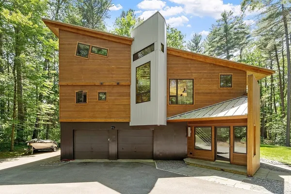 a front view of a house with a garden
