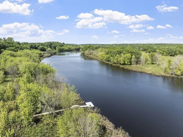 a view of a lake with a house in the background