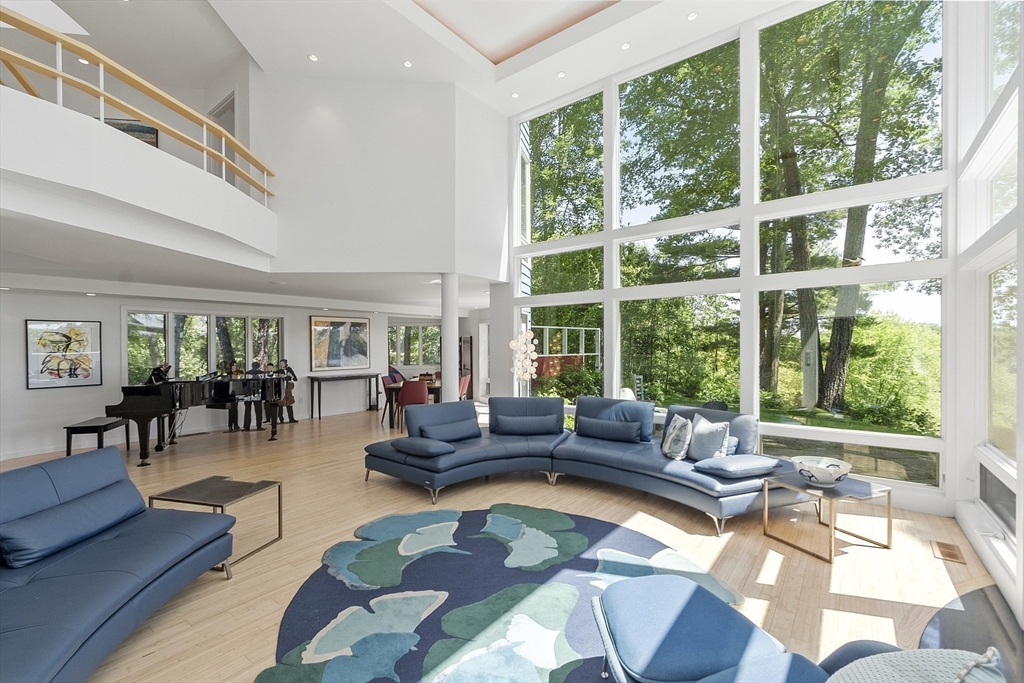 389 River Road Carlisle, MA 01741 - Photo 10 of 42 a living room with furniture and a large window