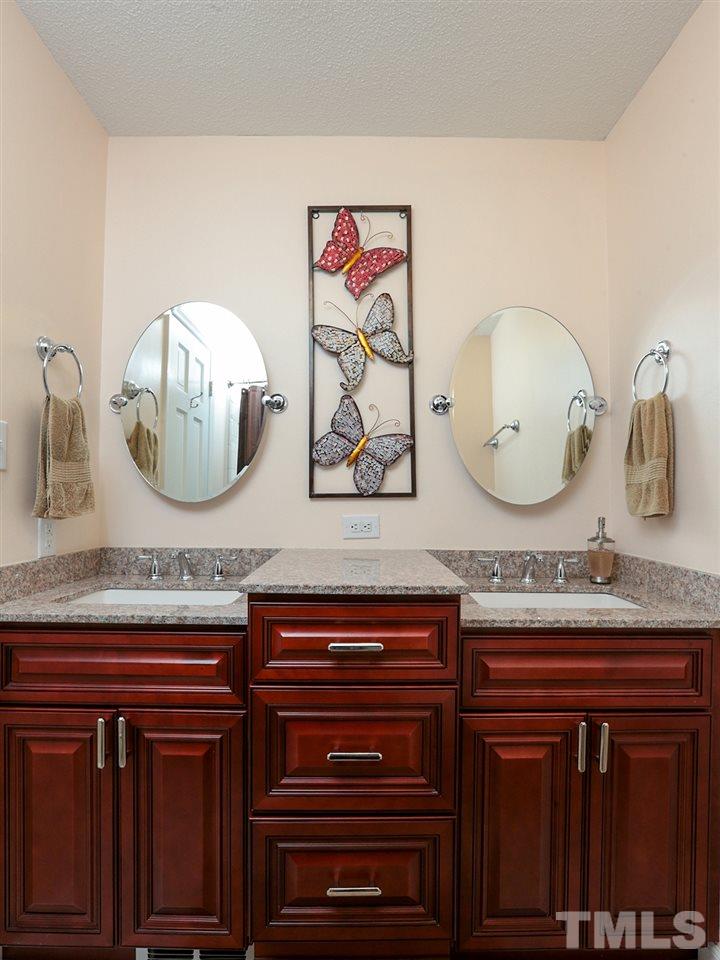 7316 Harps Mill Road Raleigh, NC 27615 - Photo 16 of 25 a bathroom with a sink and a mirror