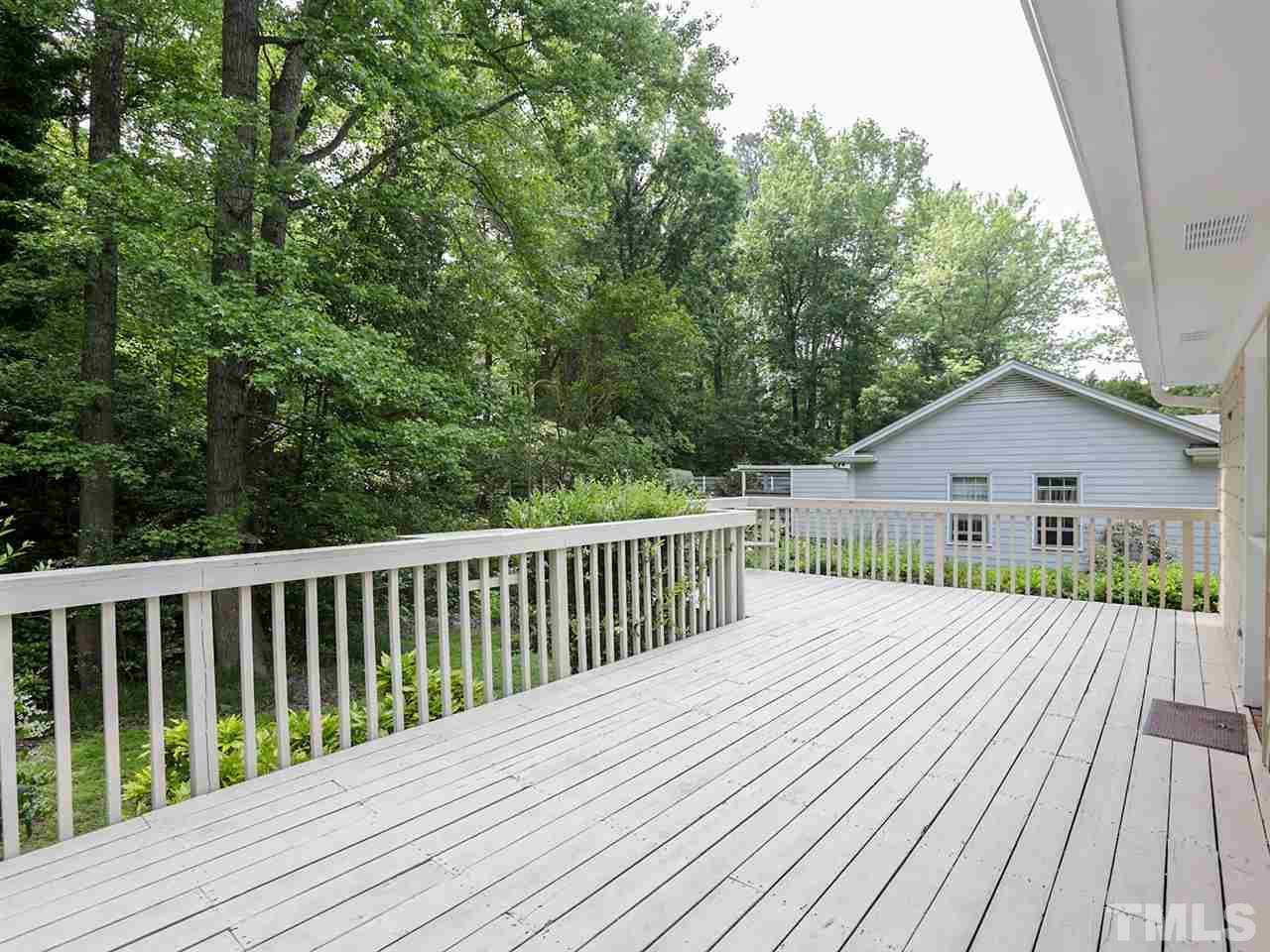 7316 Harps Mill Road Raleigh, NC 27615 - Photo 21 of 25 a view of backyard with wooden deck and trees