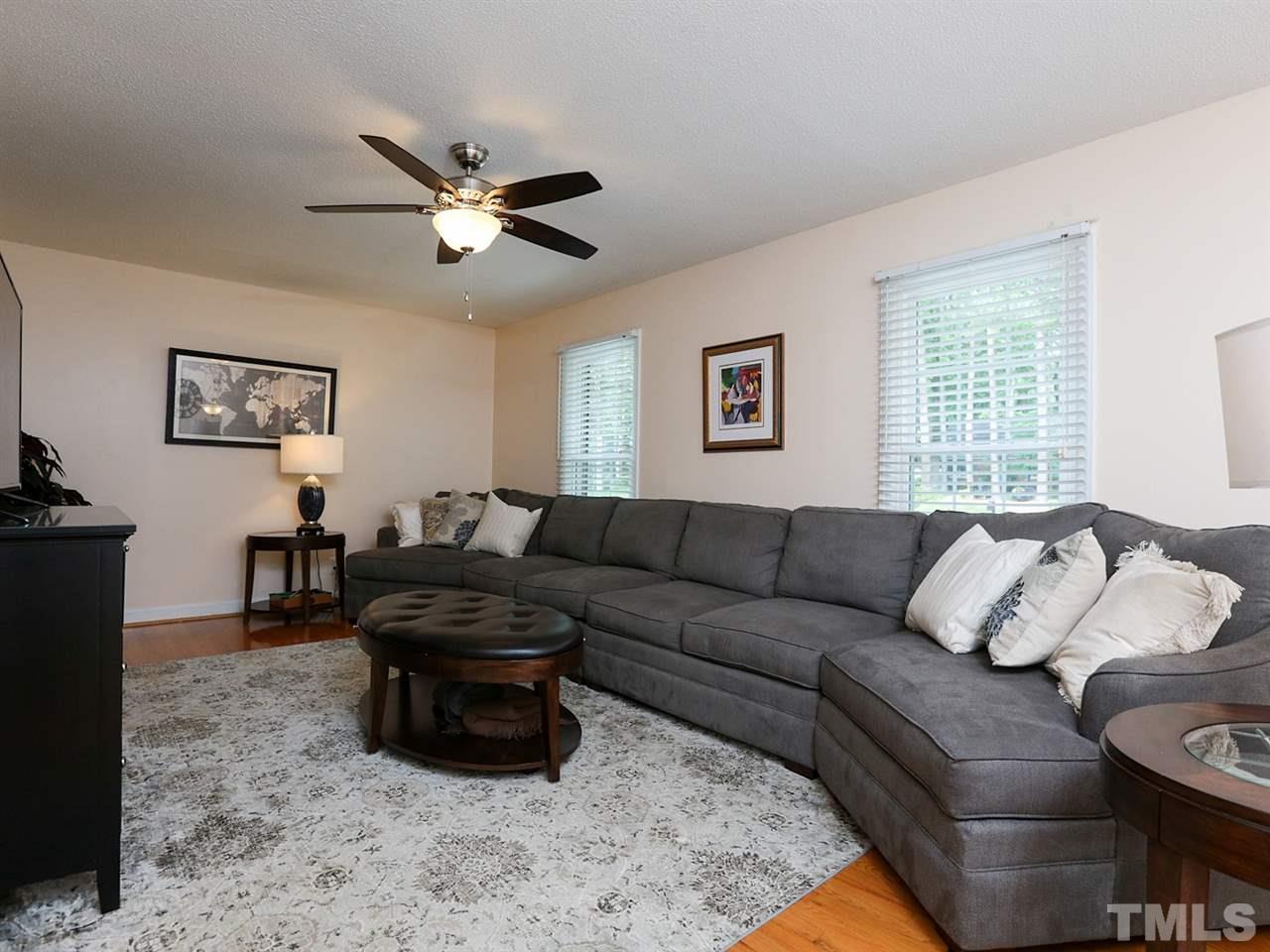 7316 Harps Mill Road Raleigh, NC 27615 - Photo 5 of 25 a living room with furniture a ceiling fan and a window