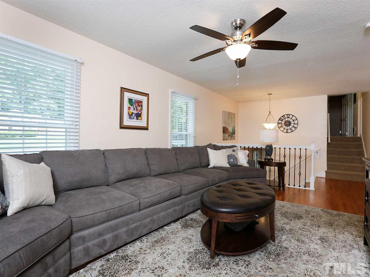 7316 Harps Mill Road Raleigh, NC 27615 - Photo 6 of 25 a living room with furniture and a ceiling fan