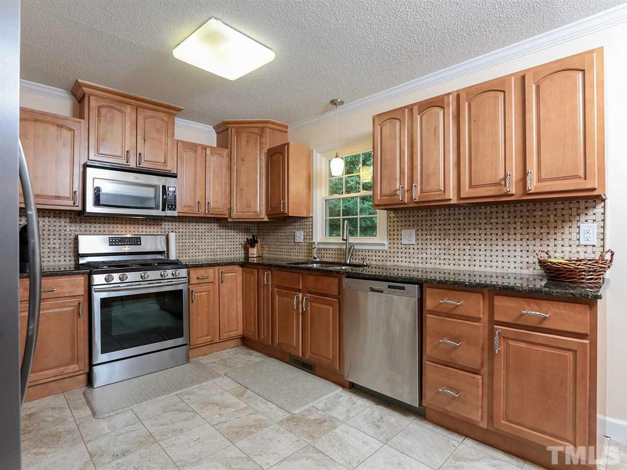 7316 Harps Mill Road Raleigh, NC 27615 - Photo 9 of 25 a kitchen with stainless steel appliances granite countertop a stove sink microwave and cabinets
