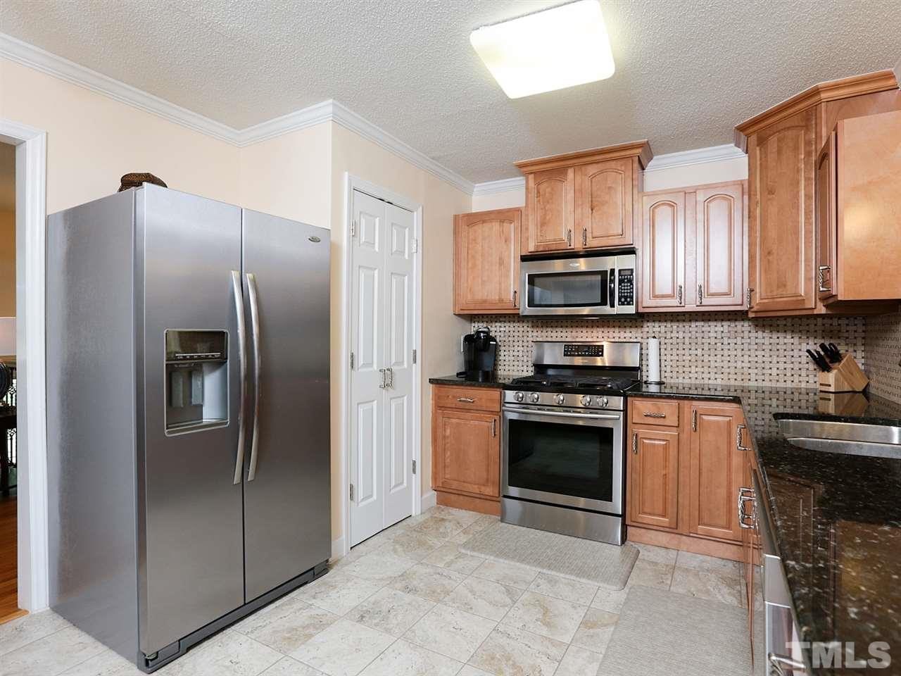 7316 Harps Mill Road Raleigh, NC 27615 - Photo 10 of 25 a kitchen with stainless steel appliances granite countertop a refrigerator stove and microwave