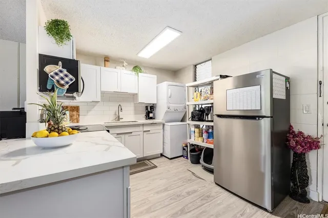 a kitchen with a refrigerator and a sink