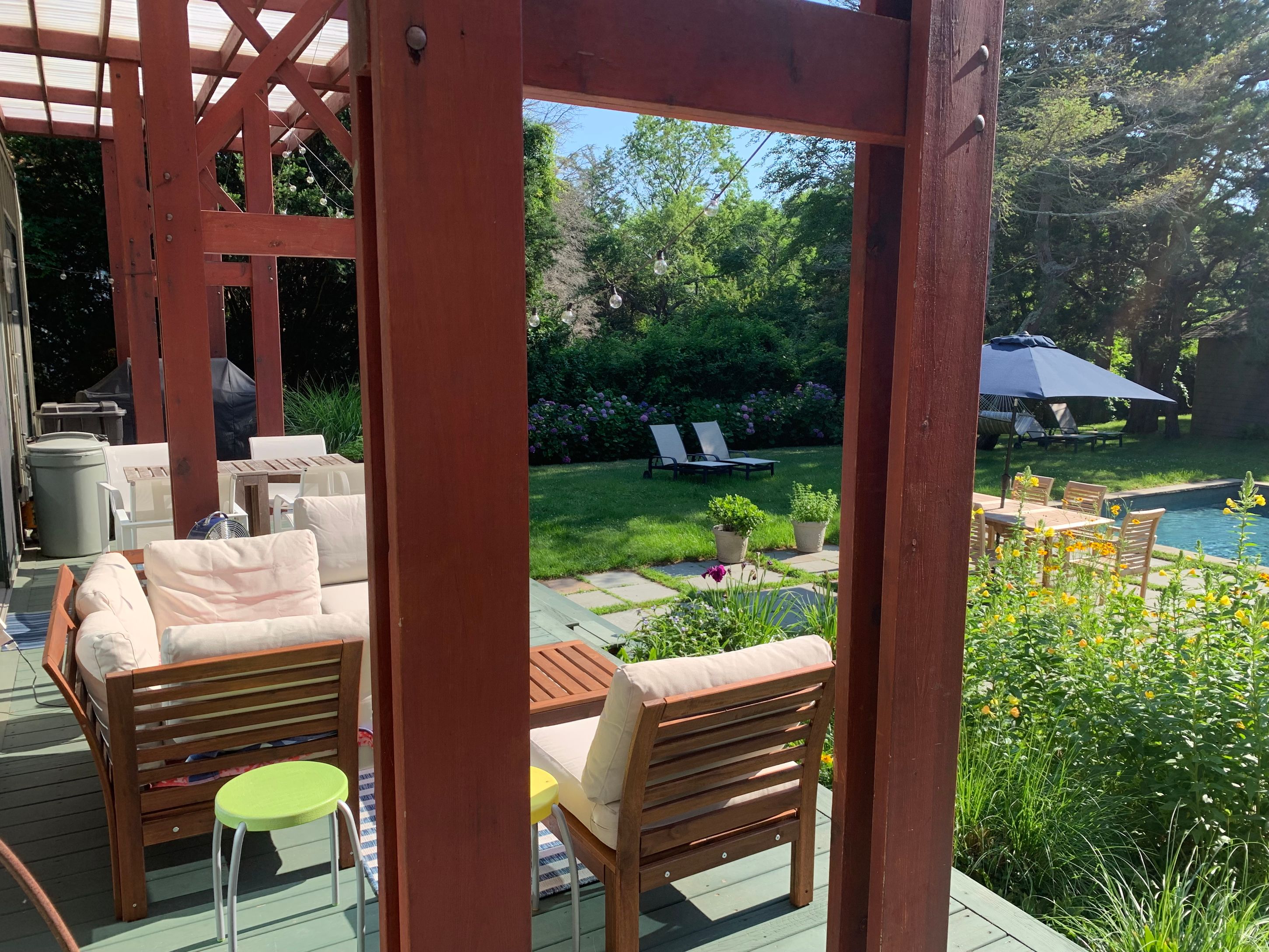 Undisclosed Address Sag Harbor, NY 11963 - Photo 15 of 18 a view of a patio with table and chairs potted plants with wooden floor