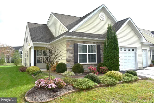 a view of a house with a yard and plants