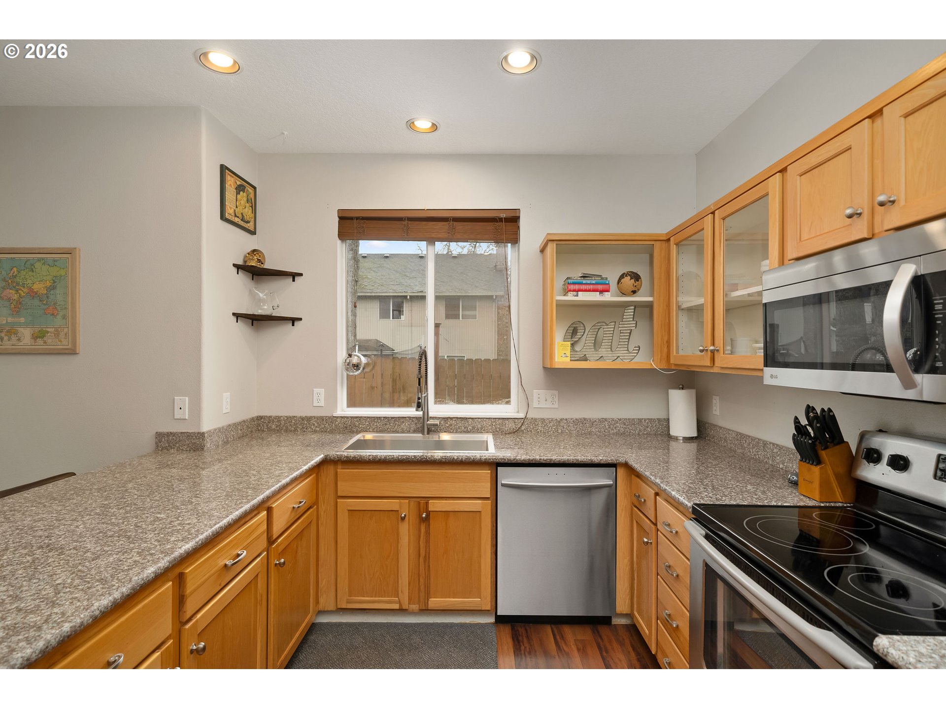 8330 Southwest Norfolk Lane Portland, OR 97224 - Photo 16 of 37 a kitchen with stainless steel appliances granite countertop a sink stove and cabinets