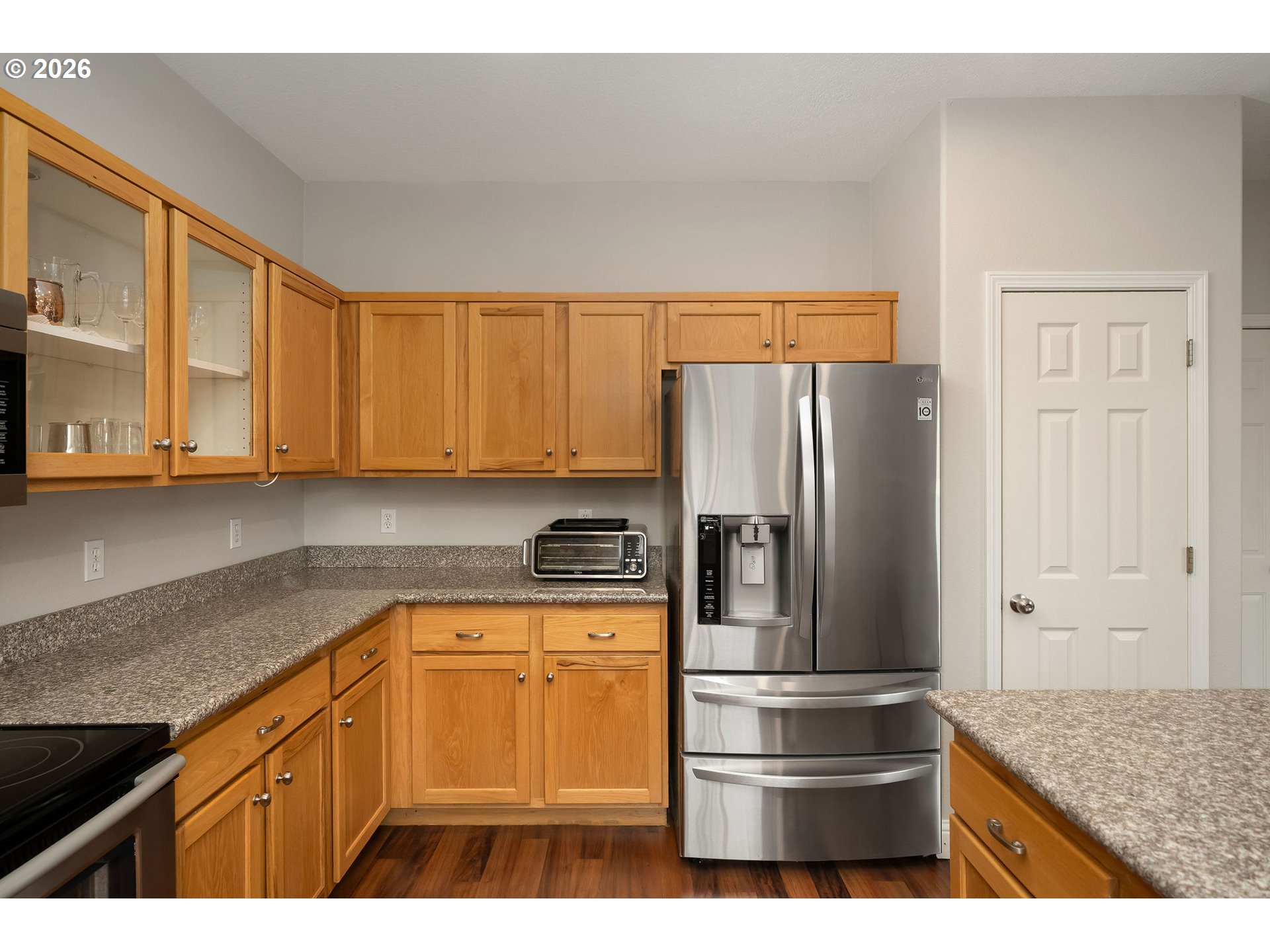 8330 Southwest Norfolk Lane Portland, OR 97224 - Photo 17 of 37 a kitchen with stainless steel appliances granite countertop a refrigerator sink and cabinets