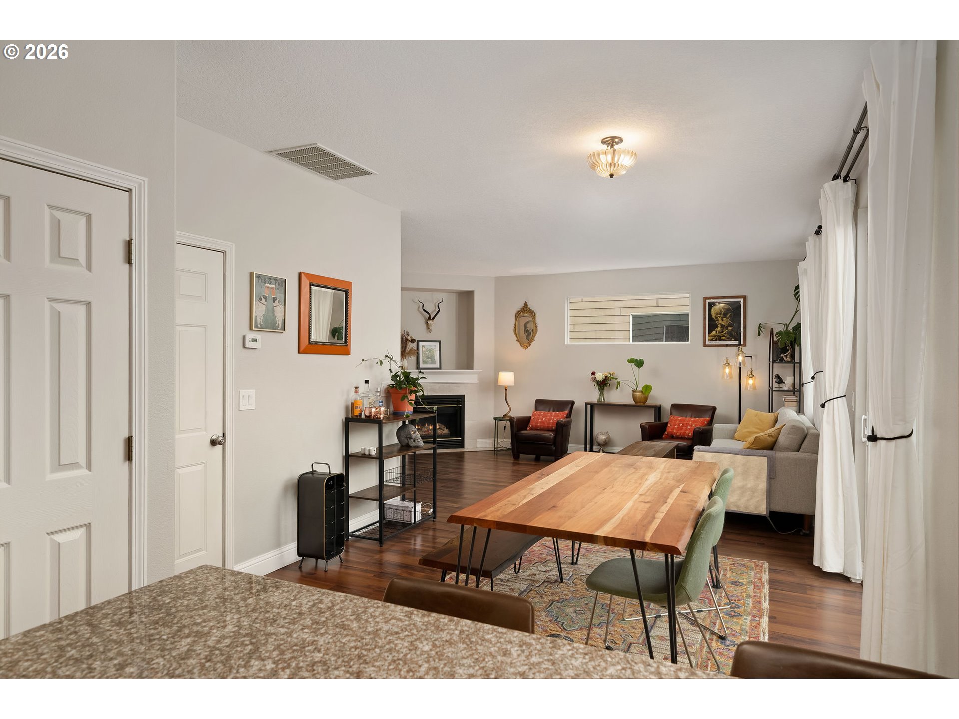 8330 Southwest Norfolk Lane Portland, OR 97224 - Photo 18 of 37 a living room with furniture a wooden floor and next to a window