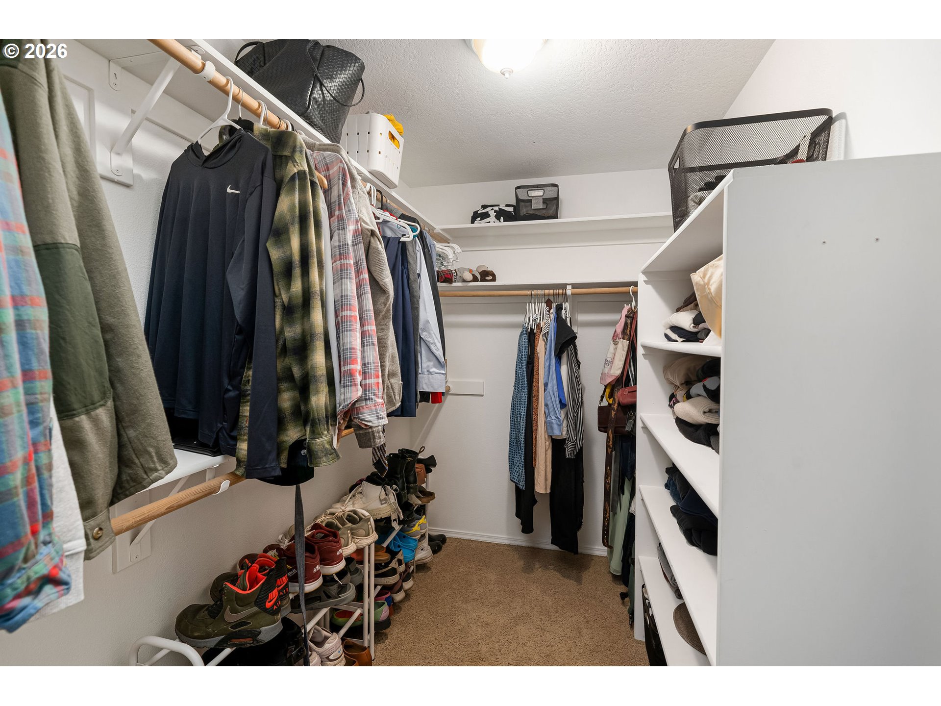8330 Southwest Norfolk Lane Portland, OR 97224 - Photo 22 of 37 a view of walk in closet with clothes and shoes