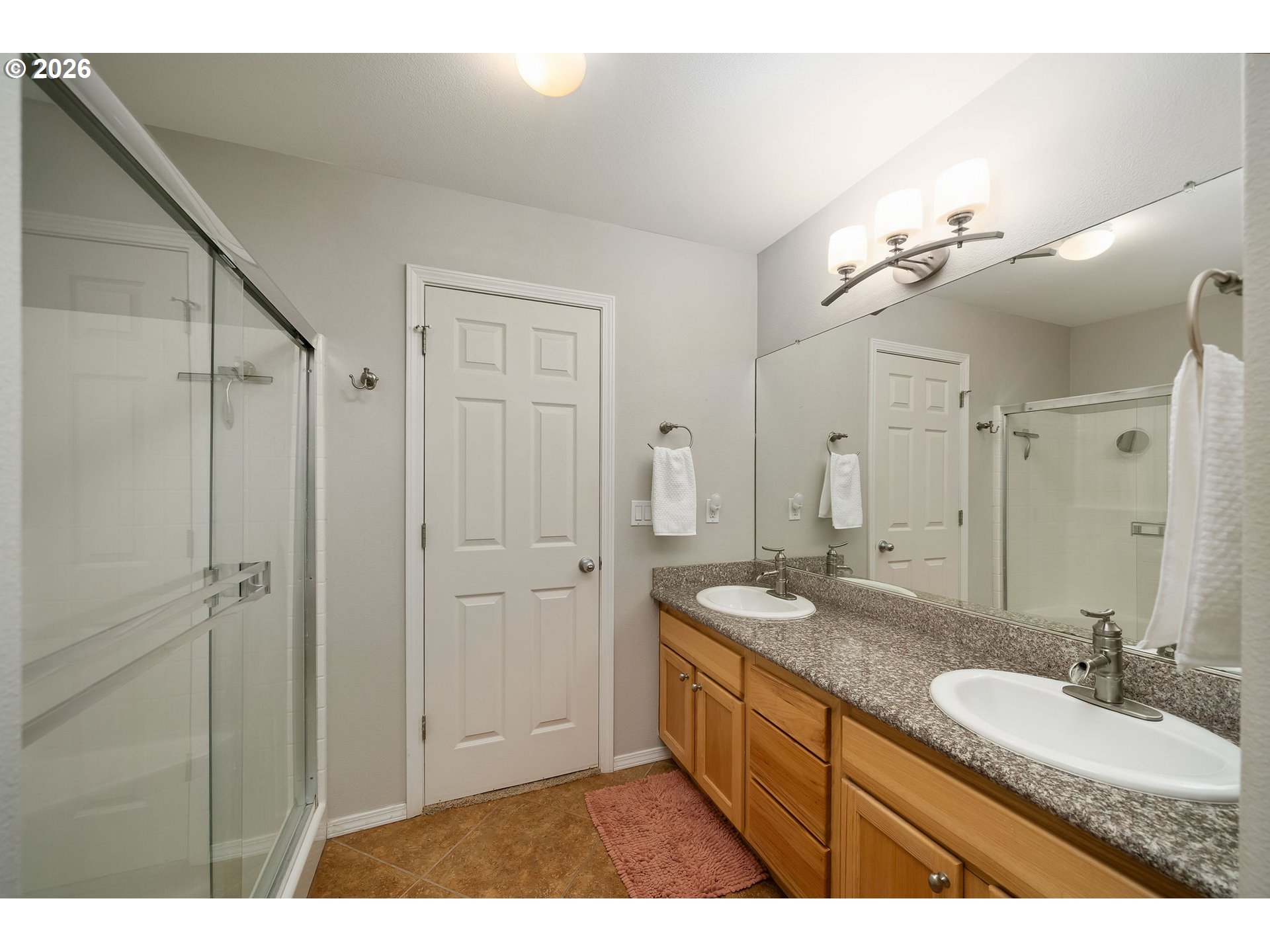 8330 Southwest Norfolk Lane Portland, OR 97224 - Photo 24 of 37 a bathroom with a granite countertop sink mirror and a shower