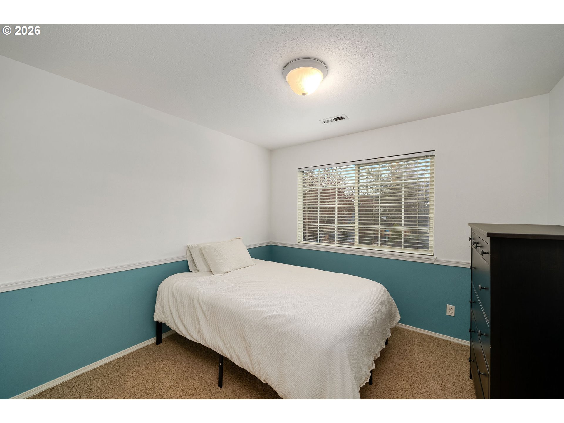 8330 Southwest Norfolk Lane Portland, OR 97224 - Photo 26 of 37 a bedroom with a bed and a window