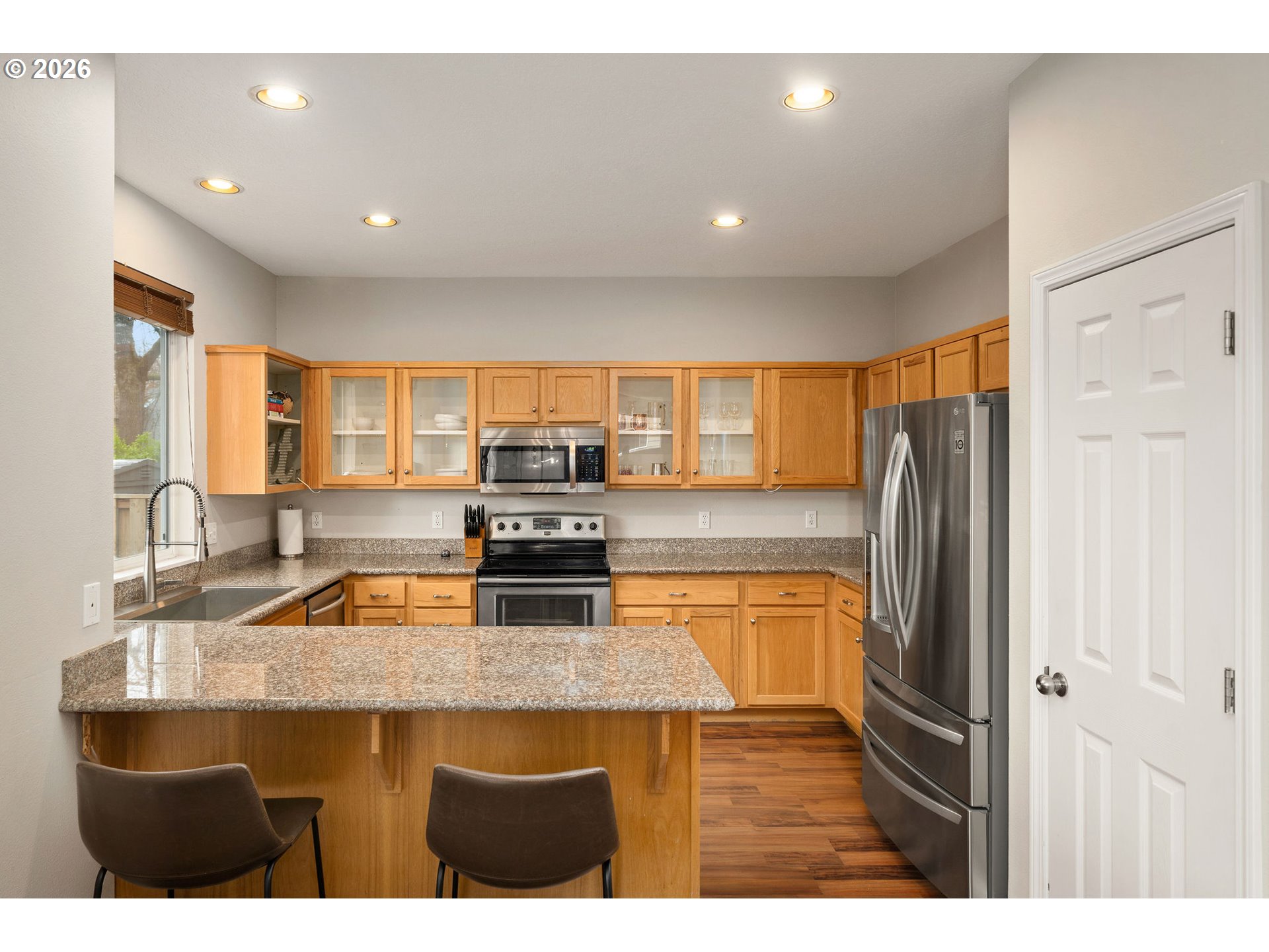 8330 Southwest Norfolk Lane Portland, OR 97224 - Photo 3 of 37 a kitchen with stainless steel appliances a sink stove and refrigerator