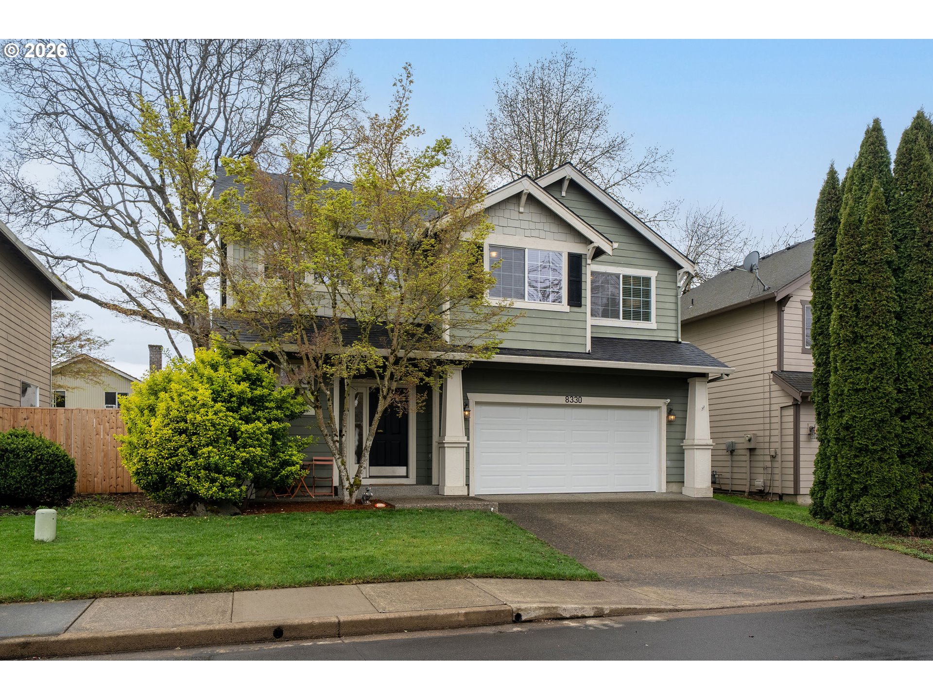 8330 Southwest Norfolk Lane Portland, OR 97224 - Photo 36 of 37 a front view of a house with a garden and garage