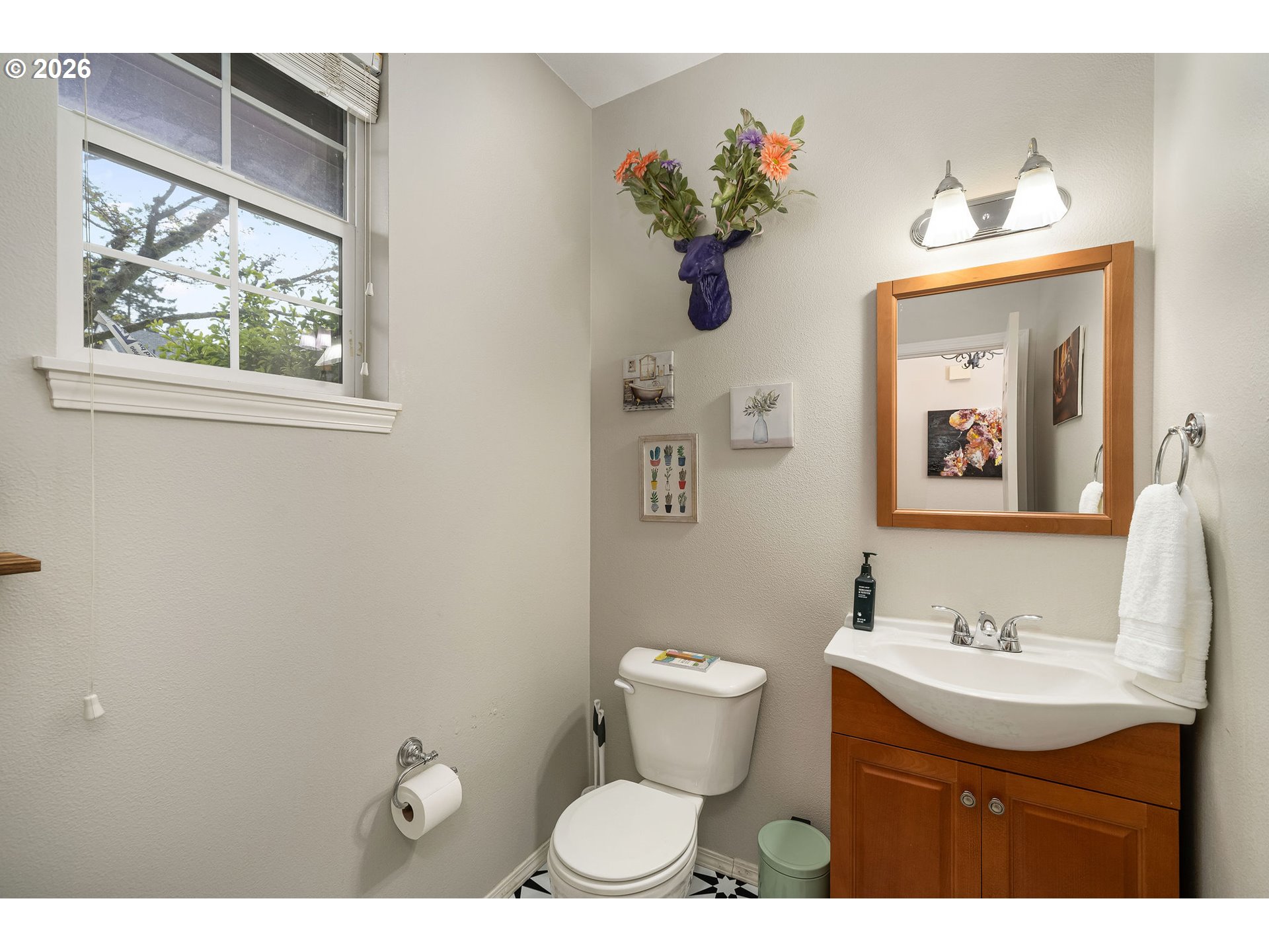 8330 Southwest Norfolk Lane Portland, OR 97224 - Photo 7 of 37 a bathroom with a toilet sink and mirror