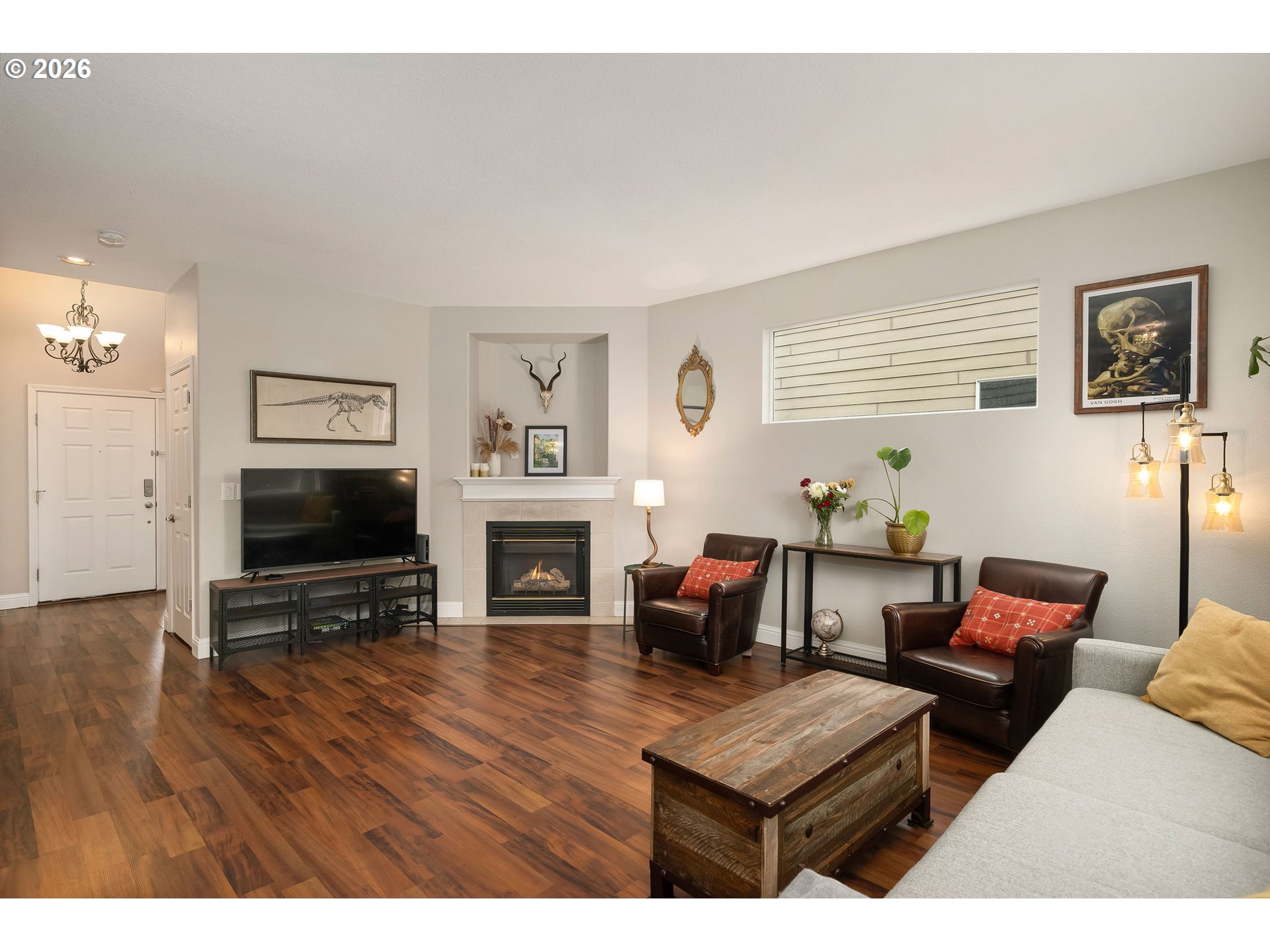 8330 Southwest Norfolk Lane Portland, OR 97224 - Photo 10 of 37 a living room with furniture a fireplace and a flat screen tv