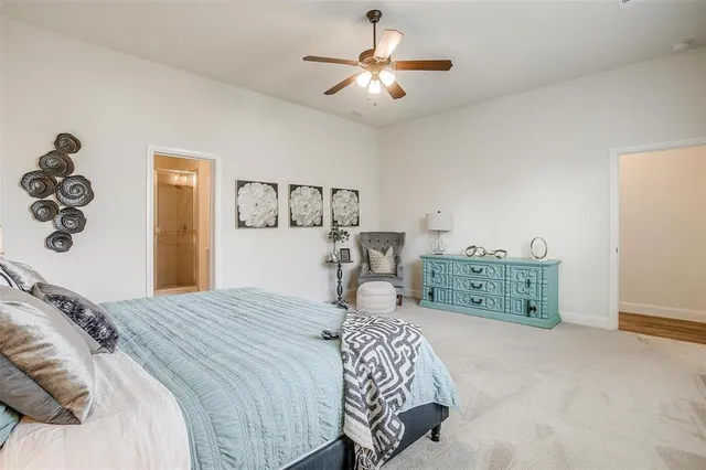 a bedroom with a large bed and a chandelier