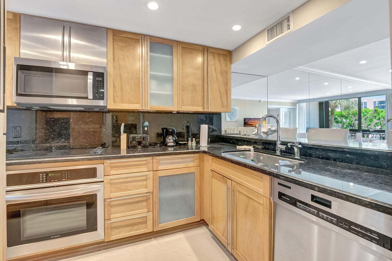 2707 North Ocean Boulevard, Unit D205 Boca Raton, FL 33431 - Photo 19 of 51 a kitchen with granite countertop stainless steel appliances white cabinets and a granite counter tops