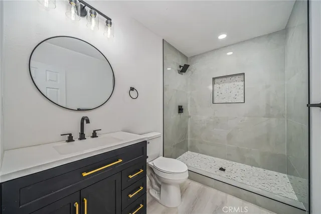 a bathroom with a sink a toilet and shower