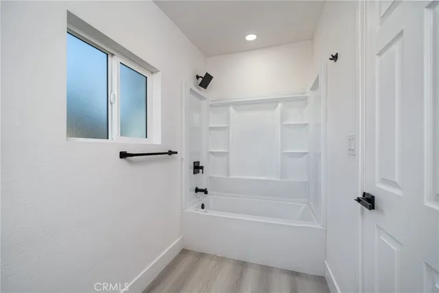 a bathroom with a bathtub and shower