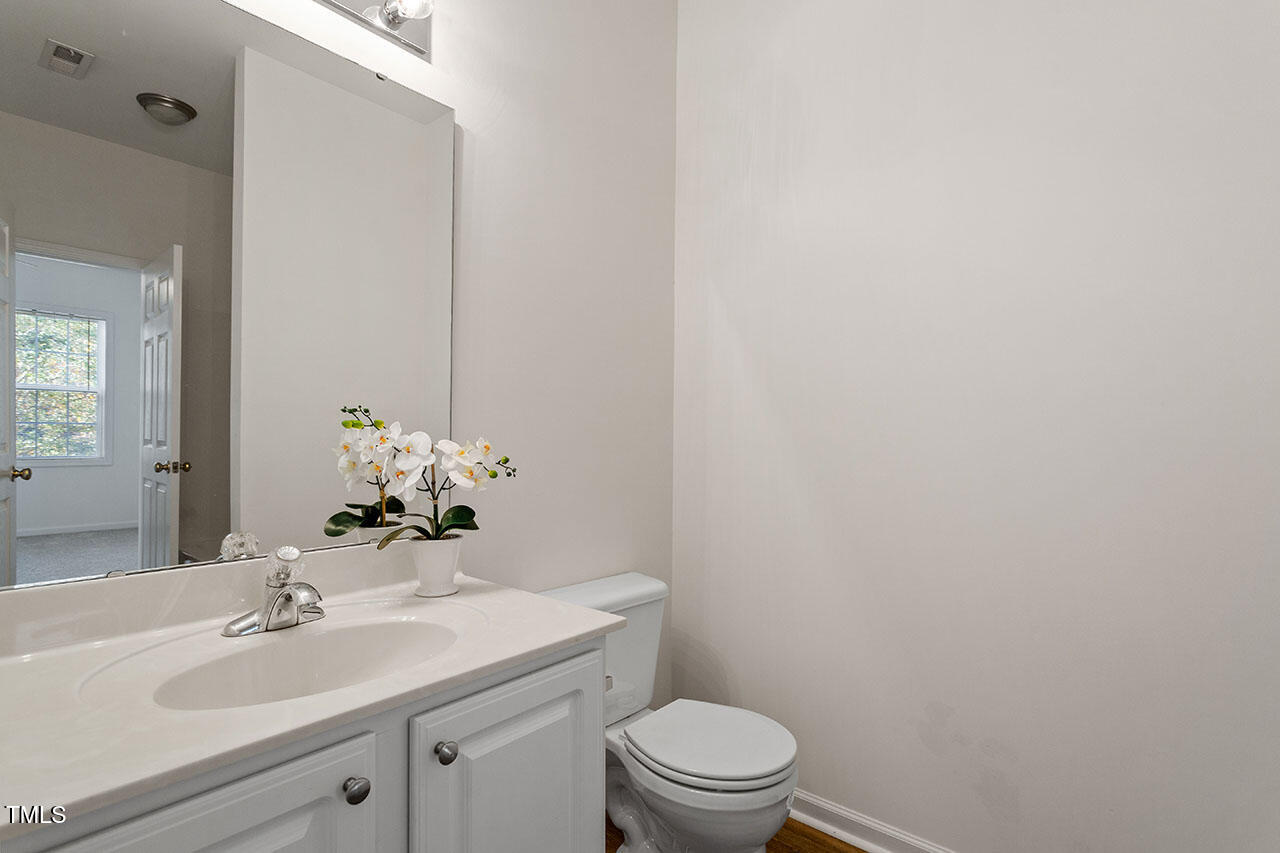 2739 Andover Glen Road Raleigh, NC 27604 - Photo 25 of 29 a bathroom with a sink a toilet and mirror