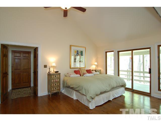 1061 Beaver Dam Road Chapel Hill, NC 27517 - Photo 11 of 19 a bedroom with a large bed and a large window
