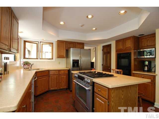 1061 Beaver Dam Road Chapel Hill, NC 27517 - Photo 14 of 19 a kitchen with stainless steel appliances granite countertop a sink stove and refrigerator