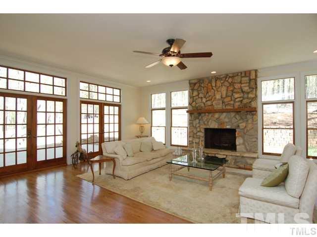1061 Beaver Dam Road Chapel Hill, NC 27517 - Photo 19 of 19 a living room with furniture a fireplace and a floor to ceiling window