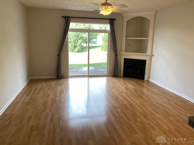 4332 Straight Arrow Road Beavercreek, OH 45430 - Photo 3 of 22 Living room with fireplace and beautiful laminate flooring.