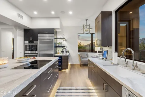 a kitchen with stainless steel appliances a sink and cabinets