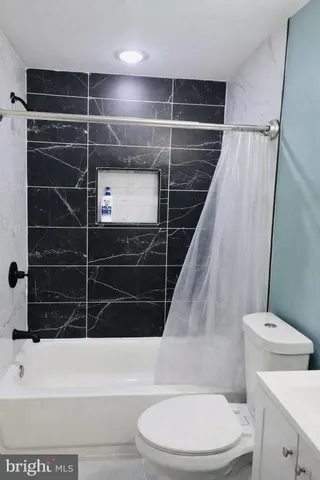 a bathroom with a sink a toilet and mirror