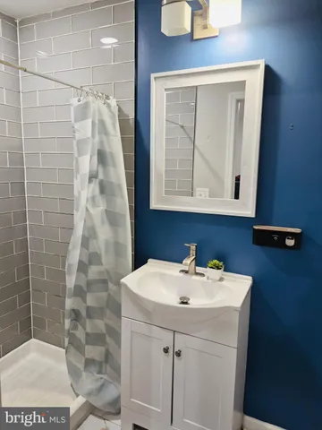 a bedroom with a bed window and shower