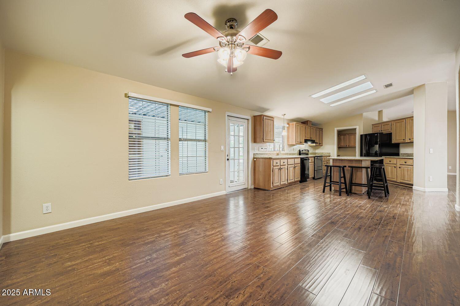 2550 South Ellsworth Road, Unit 277 Mesa, AZ 85209 - Photo 9 of 20 a view of an empty room with window and wooden floor