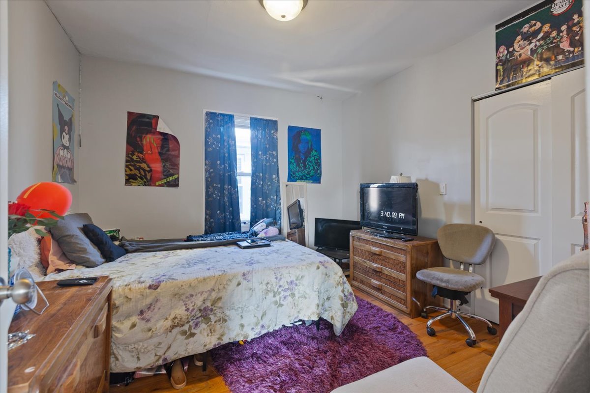 1213 Darrow Avenue Evanston, IL 60202 - Photo 7 of 16 a bedroom with bed and a flat screen tv