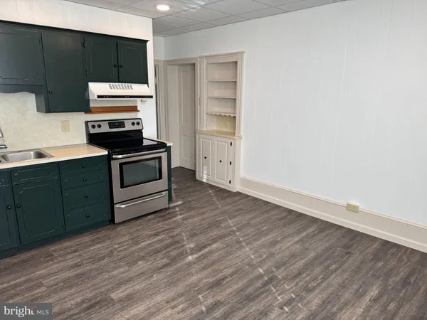 a kitchen with wooden cabinets and a stove top oven