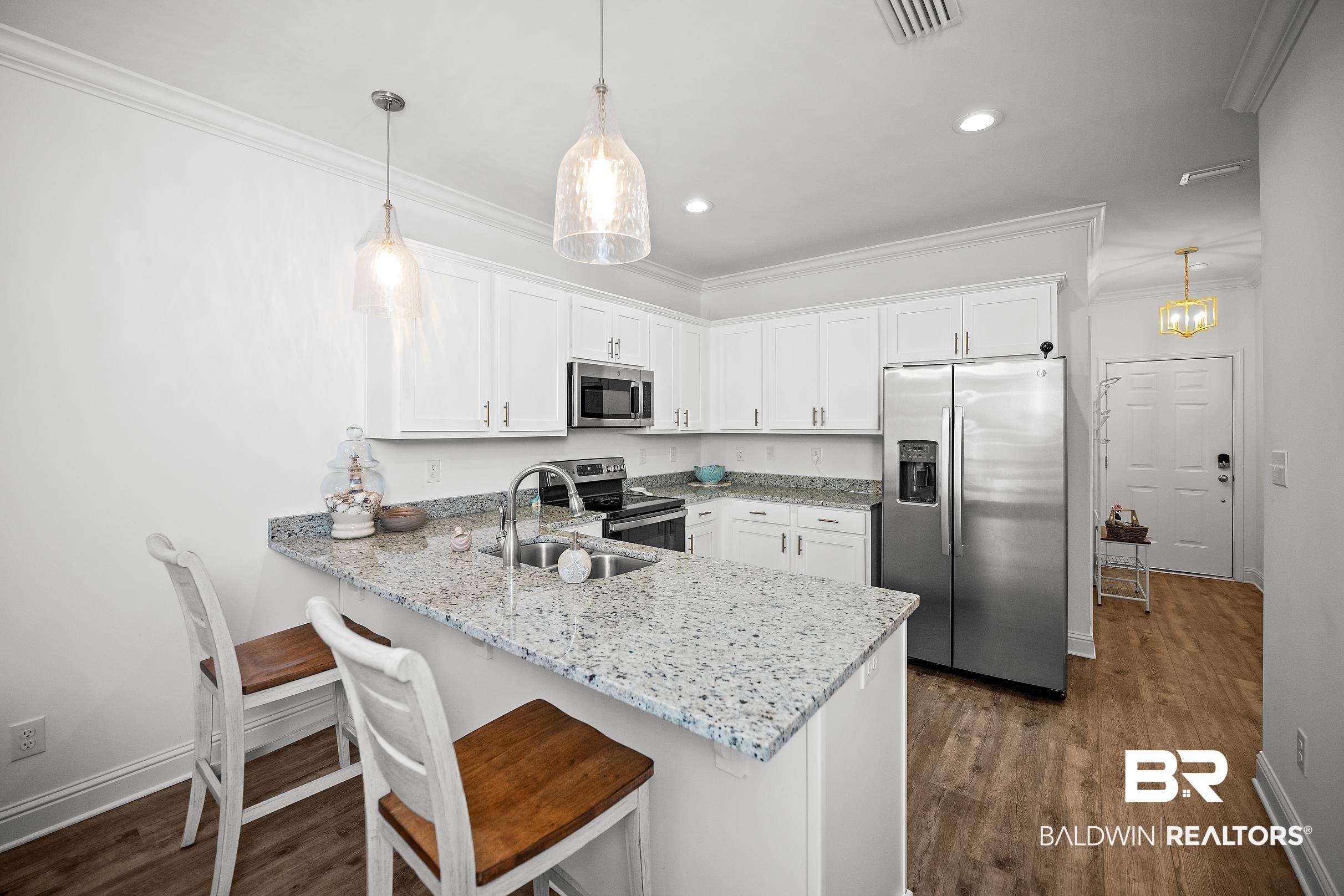 2651 South Juniper Street, Unit 2002 Foley, AL 36535 - Photo 3 of 23 Modern kitchen featuring white cabinetry, granite countertops, and stainless steel appliances