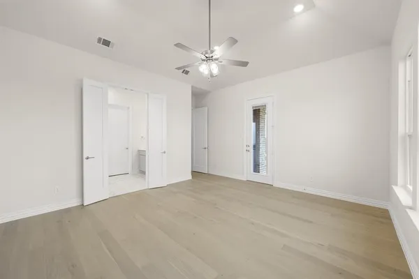 a view of an empty room with a ceiling fan