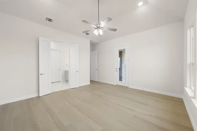 a view of an empty room with a ceiling fan