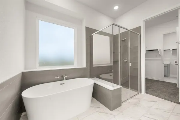 a spacious bathroom with a bathtub and a sink