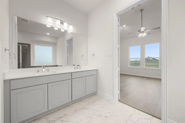 a bathroom with a double vanity sink and a mirror