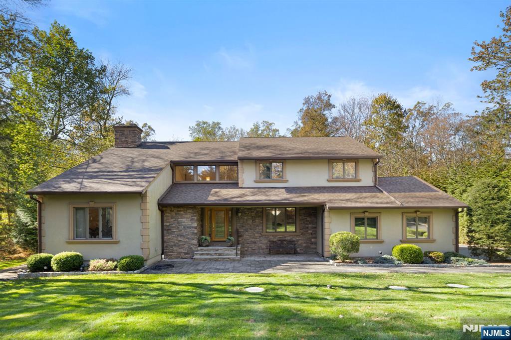 a front view of a house with a garden and plants